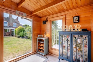A wooden interior with a sign indicating the bar is open, a wine rack, and a cabinet with glass doors. - 3 Bed in Wrentham (oc-15mill) (Wrentham)