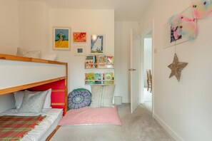 A child's bedroom with bunk beds, a bookshelf, and wall decorations. - 3 Bed in Milford On Sea (oc-f33344) (Milford on Sea)