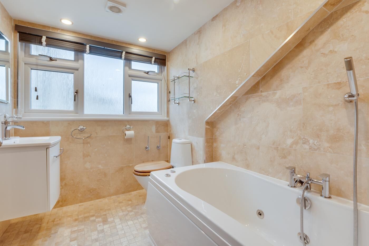 A modern bathroom with a freestanding bathtub, a toilet, and a sink.
