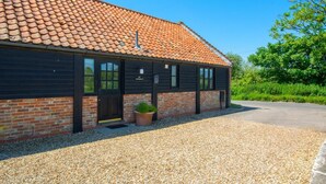 A building with a tiled roof, brick walls, and a gravel driveway. - 2 Bed in Roughton (oc-1734) (Roughton)