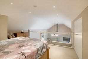 A bedroom with a bed, a nightstand, a dresser, a window with a view, and a staircase leading to an upper level. - 1 Bed in Twyford (oc-c33411) (Twyford)