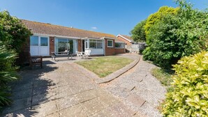A two-story house with a patio, a small garden, and a pathway leading to the entrance. - 3 Bed in Paignton (oc-bc1890) (Paignton)