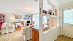 A living room with a sofa, a coffee table, a TV, and a fireplace. - 3 Bed in Paignton (oc-bc1890) (Paignton)