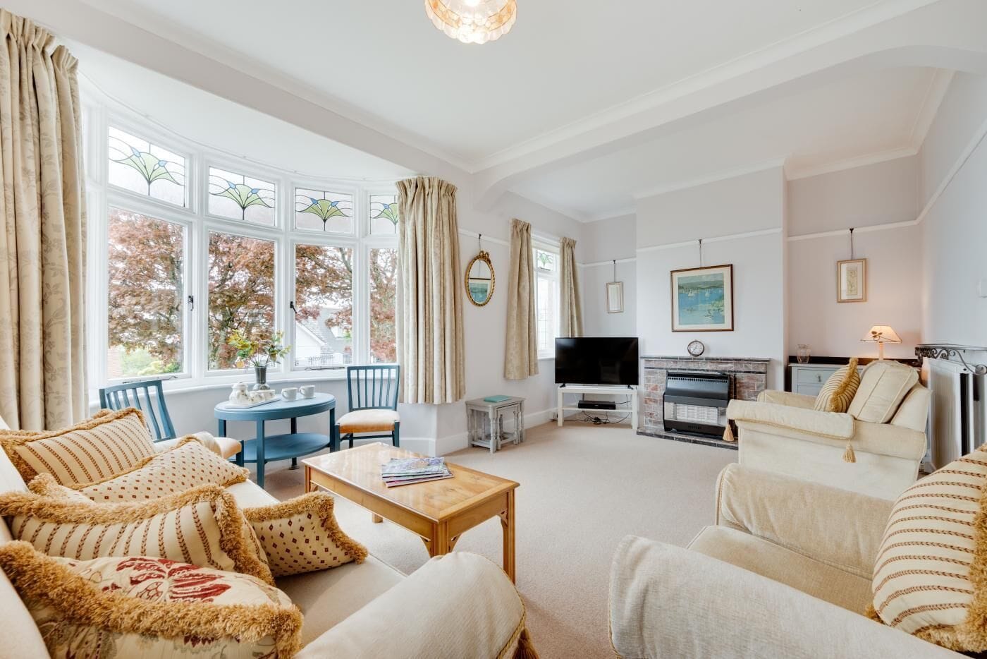 A spacious living room with a fireplace, a television, and comfortable seating.