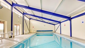 An indoor swimming pool with a blue frame, clear water, and a tiled floor. - 1 Bed in Totnes (oc-bcbove) (Broadhempston)