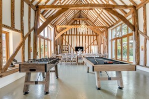 A spacious indoor area with wooden beams, a foosball table, and a pool table. - 7 Bed in Ellough (oc-g33283) (Ellough)