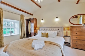 A bedroom with a large bed, a dresser, a mirror, and a window with curtains. - 4 Bed in Ellonby (oc-y33284) (Ellonby)