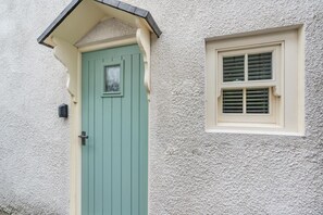 A house with a green door and a window with shutters. - 2 Bed in Whitby (oc-w134) (Whitby)