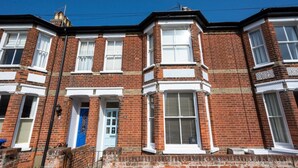 A row of terraced houses with brick facades, white window frames, and a blue door. - 3 Bed in Southwold (oc-5sr) (Southwold)