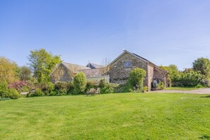 A stone house with a well-maintained lawn and garden. - 2 Bed in Bratton Fleming (oc-h33562) (Bratton Fleming)