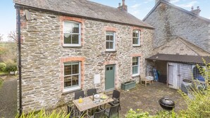 A stone house with a patio, outdoor seating, and a small shed. - 4 Bed in St. Mawgan (oc-p00610) (Saint Mawgan)