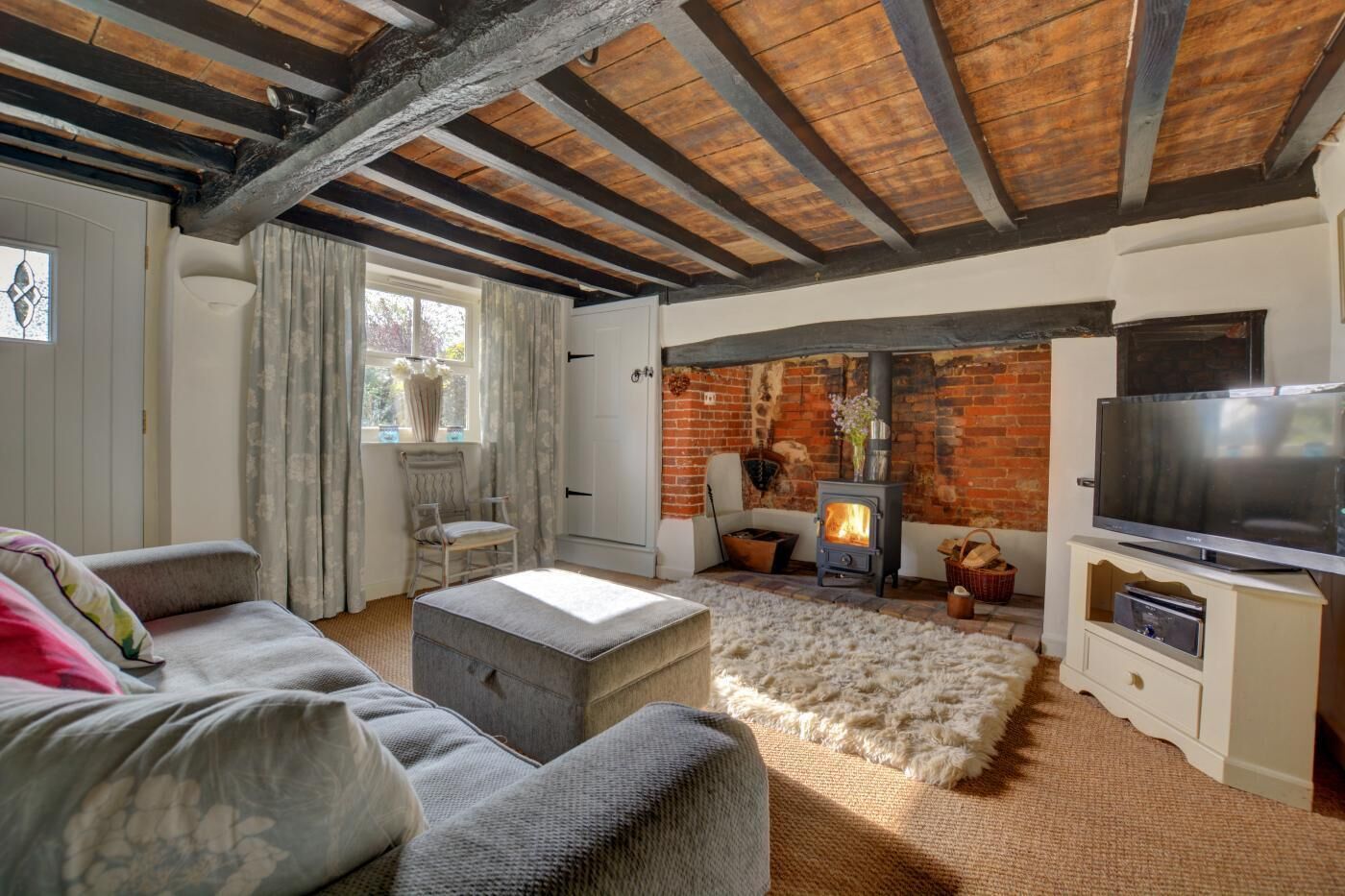 A cozy living room with a fireplace, a television, and comfortable seating.