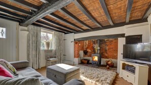 A cozy living room with a fireplace, a television, and comfortable seating. - 1 Bed in Stanhoe (oc-1792) (Stanhoe)