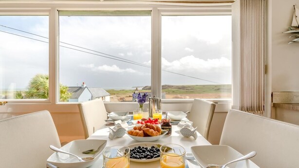 A breakfast table with croissants, blueberries, and orange juice, overlooking a scenic landscape. - 2 Bed in Penally (oc-pw9077) (Penally)