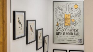 A wall with framed bird illustrations and a poster advertising the Rye Harvest Wine & Food Fair. - 2 Bed in Peasmarsh (oc-s33528) (Peasmarsh)