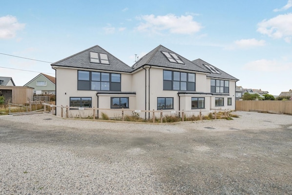 A two-story residential building with a gravel driveway and a wooden fence. - 2 Bed in Tintagel (oc-p33627) (Tintagel)