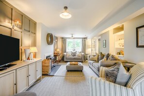 A spacious living room with a television, sofas, a fireplace, and a ceiling fan. - 3 Bed in Barbon (oc-b33652) (Barbon)