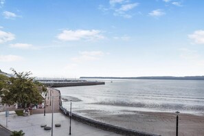 A coastal promenade with a stone wall, a pier, and a clear view of the sea. - 2 Bed in Torquay (oc-a33462) (Torquay)