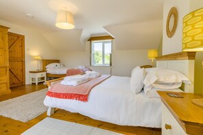 A bedroom with a bed, bedside tables, a window, and a door. - 2 Bed in Dolgellau (oc-75787) (Dolgellau)