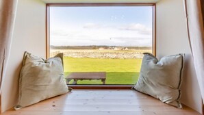 A room with a large window, a wooden floor, and two pillows. - 1 Bed in Wick (oc-b33442) (Wick)
