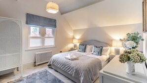A bedroom with a bed, bedside tables, a radiator, a window with blinds, and a ceiling fan. - 3 Bed in Buxton (oc-c33947) (Buxton)