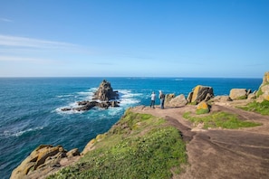 A coastal landscape with rocky terrain and a clear view of the ocean. - 3 Bed in Sennen (oc-cpz56) (Sennen)