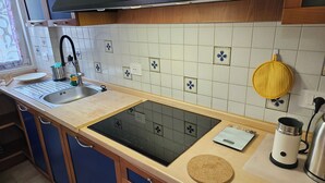 A kitchen with a sink, stove, and various appliances. - Three-room In Tortona District (Milano)