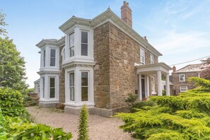 A stone building with multiple windows and a covered porch. - 7 Bed in Mousehole (oc-boslan) (Paul)