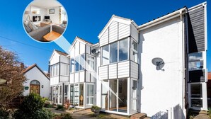 A modern two-story house with large windows and a balcony. - 2 Bed in Sheringham (oc-2264) (Sheringham)