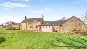 A stone house with a red door, a large lawn, and a stone barn. - 5 Bed in Shiskine (oc-b33664) (Shiskine)