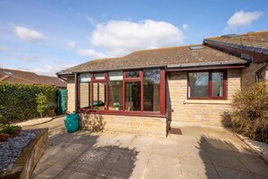 A house with a stone facade, large windows, and a tiled roof. - 2 Bed in Seahouses (oc-nb1974) (North Sunderland)