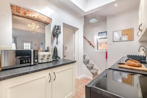 A modern kitchen with a toaster, kettle, and a bread loaf on the counter. - 2 Bed in Aldborough (oc-2257) (Aldborough)