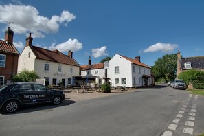 A street view with a pub named 'The Cricketers' and a black car parked in front. - 2 Bed in Aldborough (oc-2257) (Aldborough)