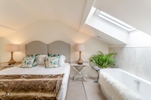 A bedroom with a large bed, a smaller bed, a nightstand, a lamp, a plant, and a skylight. - 2 Bed in Dunsop Bridge (oc-w33524) (Dunsop Bridge)