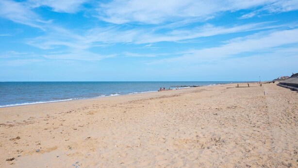 A wide sandy beach with a clear sky and calm sea. - 2 Bed in Walcott (oc-2282) (Walcott)
