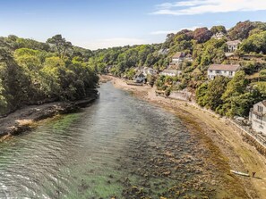 A river flowing through a residential area with houses on both sides.