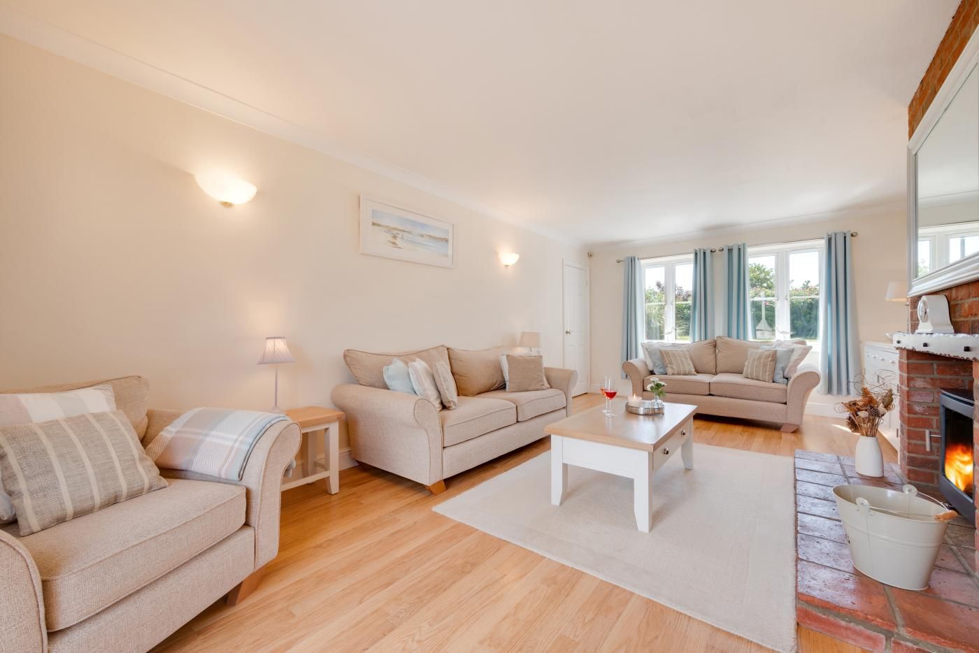 A spacious living room with two sofas, a coffee table, and a fireplace.
