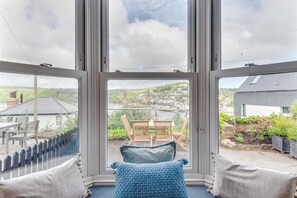 A room with a large window offering a view of a harbor and buildings. - 2 Bed in Dartmouth (oc-sd84ab) (Dartmouth)
