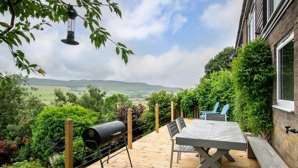 A patio with a table and chairs, a barbecue grill, and a view of the countryside. - 3 Bed in Rothbury (oc-nb1976) (Rothbury)