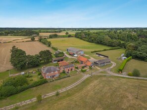 An aerial view of a rural property with fields, a farmhouse, and barns. - 1 Bed in Snape (oc-fcf) (Snape)