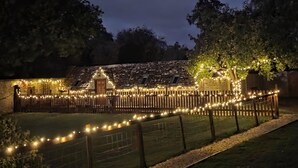 A house with a wooden fence, string lights, and a tree. - 2 Bed in Latton (oc-c34099) (Latton)