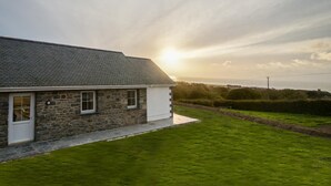 A stone house with a sloped roof and a small front porch. - 3 Bed in Llanon (oc-porth) (Llan-non)