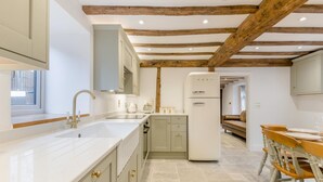 A modern kitchen with white cabinets, a double sink, and a built-in oven. - 4 Bed in Peterchurch (oc-s34019) (Peterchurch)