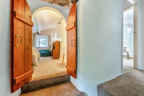 A hallway leading to a bedroom with a window, a green bean bag, and a wooden wardrobe. - 5 Bed in Wigton (oc-b34111) (Caldbeck)