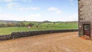 A rural landscape with a stone building, a gravel path, and a 'Give Way' traffic sign. - 2 Bed in Earl Sterndale (oc-p33566) (Earl Sterndale)