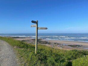A directional signpost with multiple arrows pointing towards various destinations.