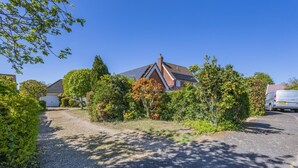 A residential area with houses, a driveway, and a parked van. - 2 Bed in Snape (oc-12sf) (Snape)