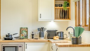 A kitchen with a microwave, toaster, kettle, and a book titled 'Sherwood Forest'. - 1 Bed in Farnsfield (oc-s34109) (Farnsfield)