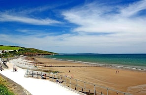 A beach with a sandy shore, a promenade, and a sea wall. - 1 Bed in Stepaside (oc-pw9268) (Amroth)