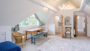 A room with a sloped ceiling, a desk, a chair, a bench, and a large window. - 3 Bed in Ufford (oc-sfmea) (Ufford)